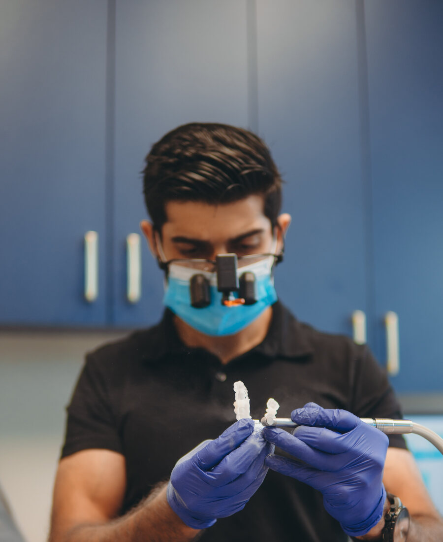 Dr. Omair Khan treating a patient at Khan Dental Studio in Fort Worth